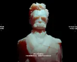 Rzeźba przedstawia Friedricha Nietzschego, symbolizując jego filozofię woli mocy. Adam Jank i Wiele Masek Woli Mocy.