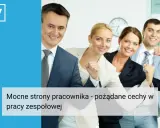 Uśmiechnięci pracownicy w garniturach, pokazujący zaciśnięte pięści w geście sukcesu.
