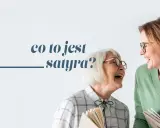 Dwie kobiety w okularach śmieją się, trzymając książki. Tekst: "co to jest satyra?".